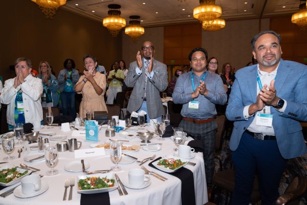People standing to applaud awardees