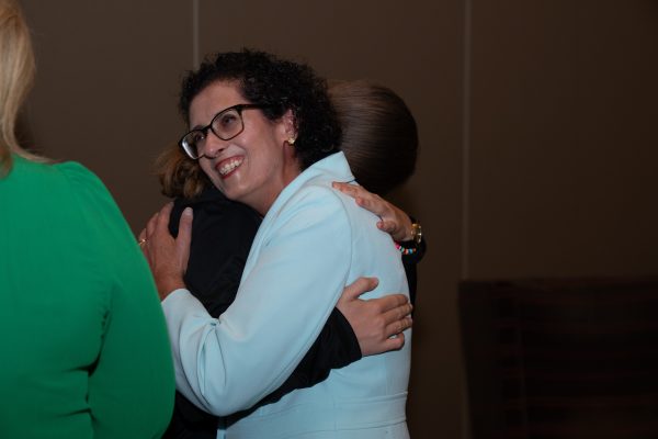 Dr. Carol Feghali-Bostwick hugging a family member.